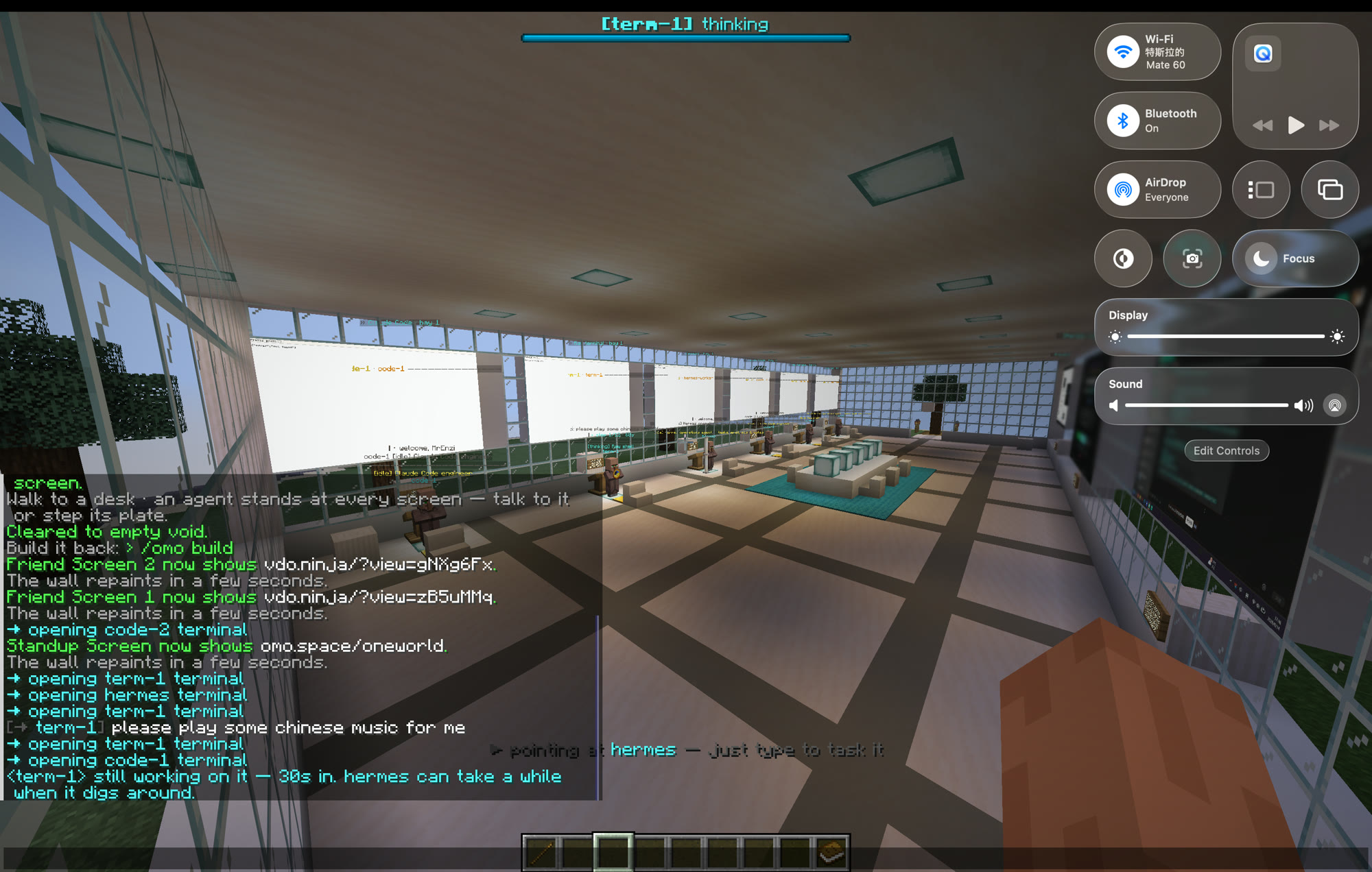 A wide view of the shared Minecraft world with the whole team's stations and screens